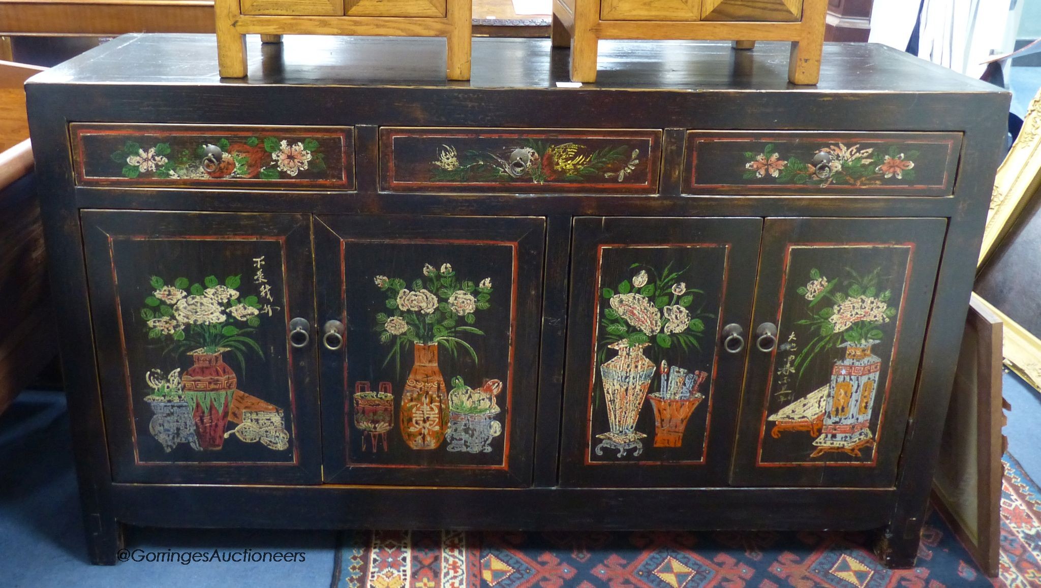A Chinese black and polychrome painted dresser, fitted three drawers over cupboards, length 156cm, depth 46cm, height 92cm